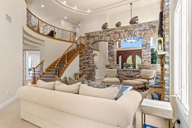 5023 Windsor Dr, San Diego, CA 92109 - carpeted living area featuring decorative columns, recessed lighting, a towering ceiling, stairway, and healthy amount of natural light