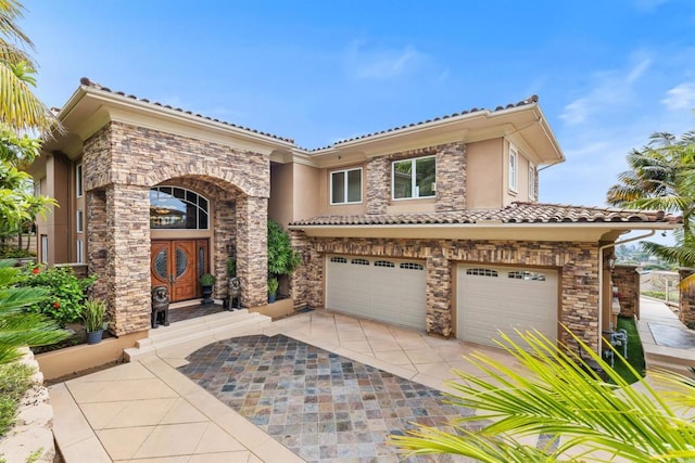 5023 Windsor Dr, San Diego, CA 92109 - mediterranean / spanish house with a garage, stucco siding, driveway, a tiled roof, and stone siding