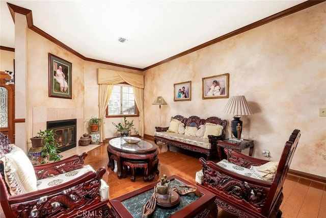 41504 Mission Dr, Palmdale, CA 93551 - living room with hardwood / wood-style floors, crown molding, and a tile fireplace