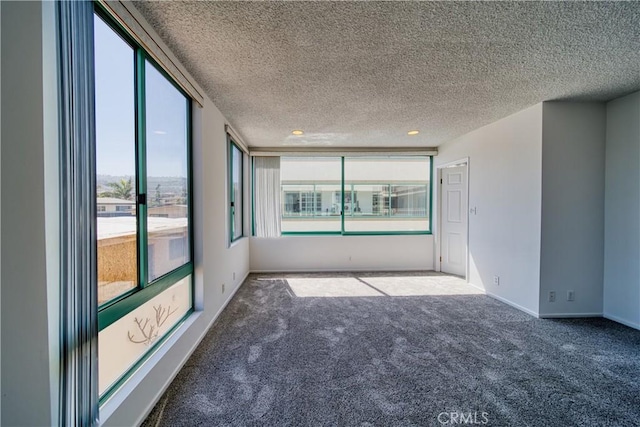 201 Calle Miramar Unit 16, Redondo Beach, CA 90277 - empty room with carpet floors, a textured ceiling, and baseboards