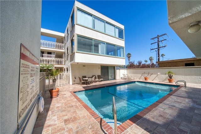 201 Calle Miramar Unit 16, Redondo Beach, CA 90277 - back of property with stucco siding, a community pool, a patio, and fence