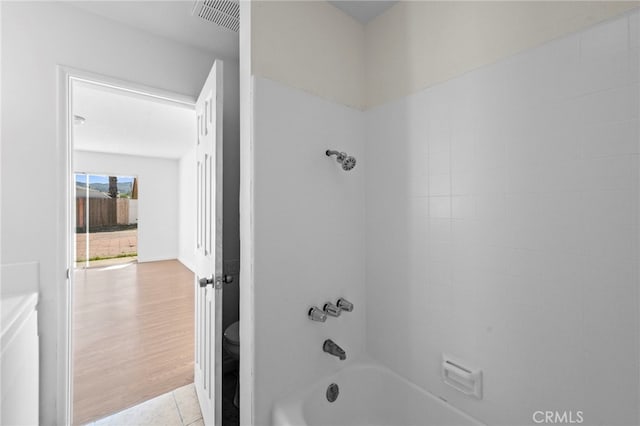 bathroom with visible vents, tile patterned flooring,  shower combination, and toilet
