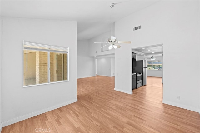 unfurnished living room with visible vents, baseboards, light wood-style flooring, high vaulted ceiling, and ceiling fan