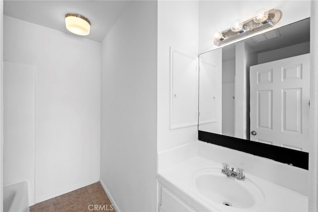 bathroom featuring baseboards, tile patterned flooring, and vanity