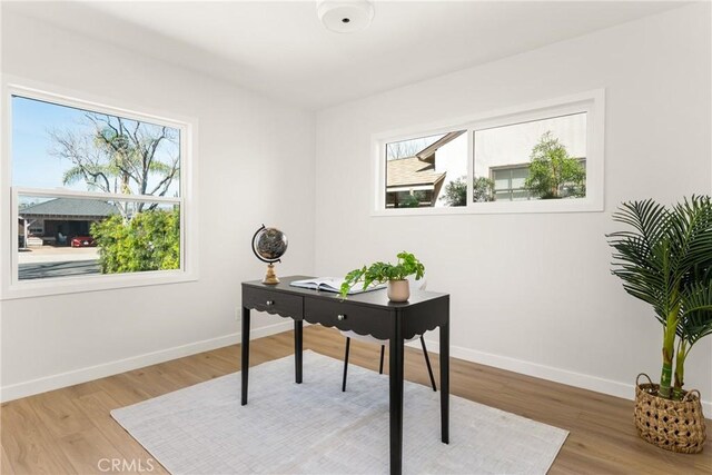 office featuring baseboards and wood finished floors