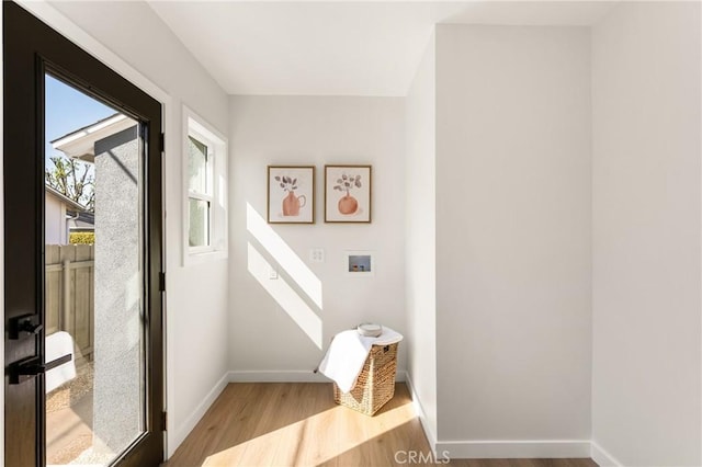 interior space featuring baseboards and wood finished floors