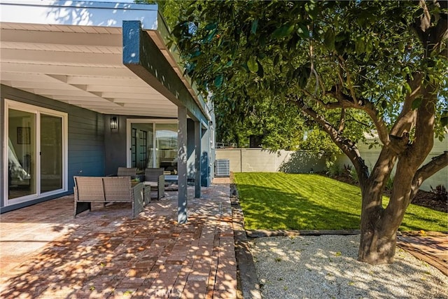 view of yard with cooling unit, an outdoor hangout area, fence, and a patio
