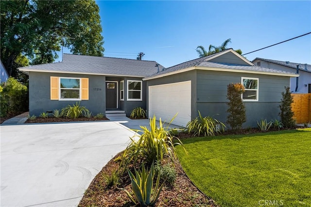 ranch-style house with fence, an attached garage, stucco siding, a front lawn, and driveway