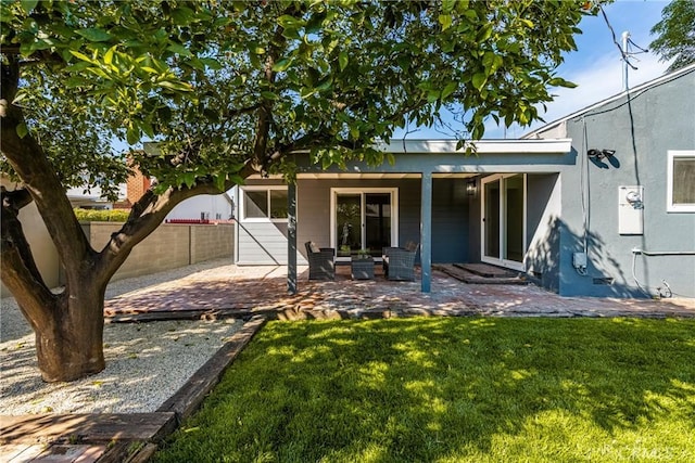 exterior space featuring a patio area, fence, and a yard