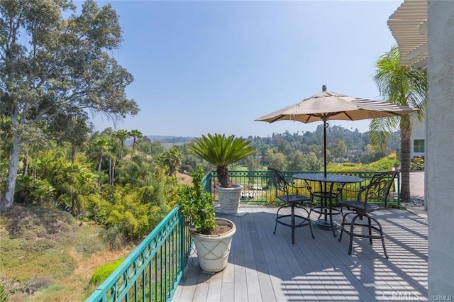 wooden terrace with outdoor dining space