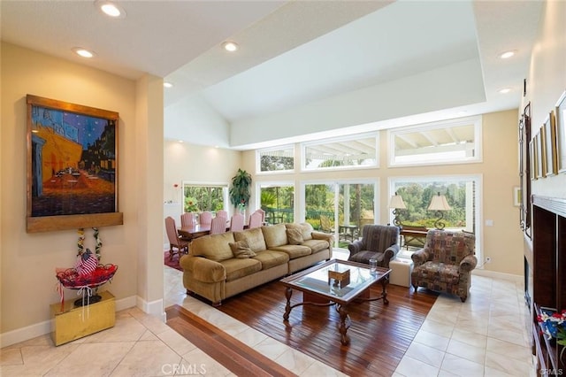 living area featuring light tile patterned floors, baseboards, and recessed lighting