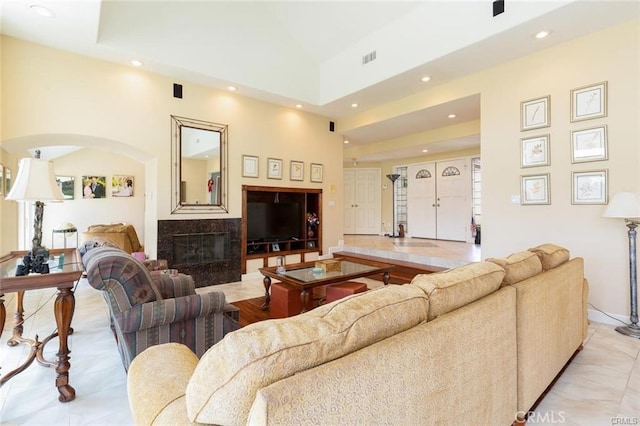 living area featuring a fireplace, visible vents, and recessed lighting