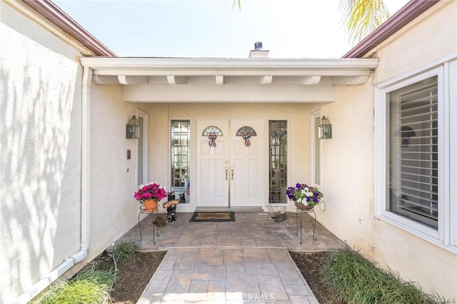 entrance to property with stucco siding