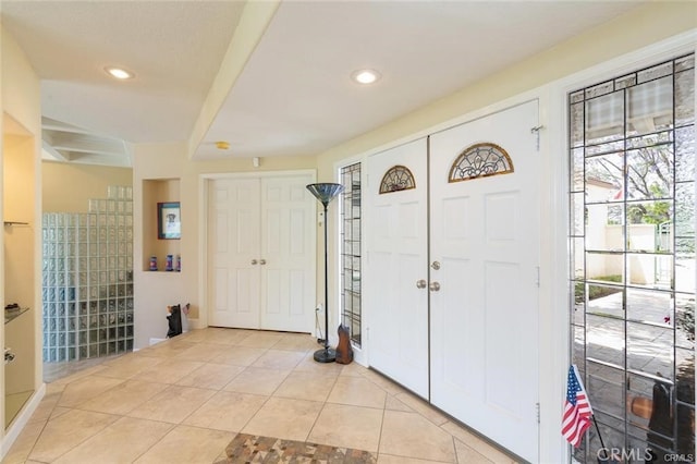 entrance foyer with light tile patterned floors and recessed lighting
