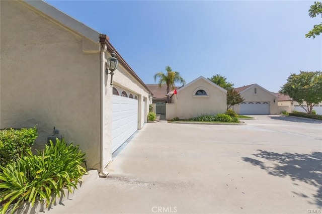 garage featuring concrete driveway