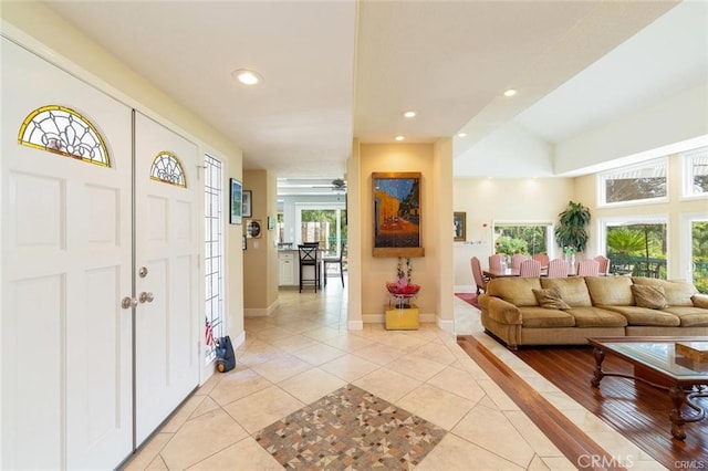 entrance foyer featuring baseboards, a ceiling fan, recessed lighting, and light tile patterned floors