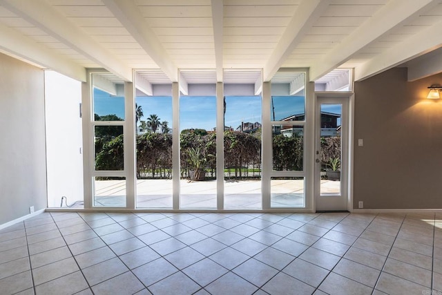 1801 Coast Blvd, Del Mar, CA 92014 - unfurnished room with a wall of windows, beamed ceiling, tile patterned floors, and baseboards