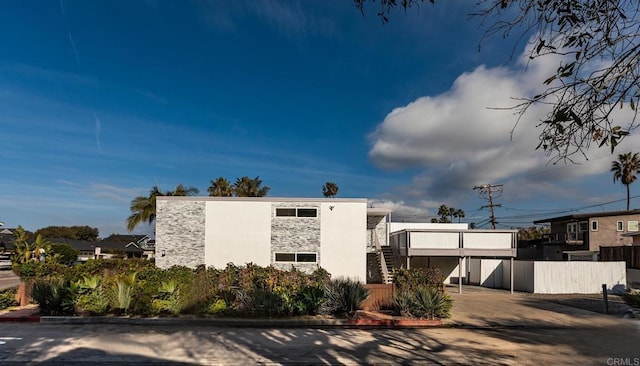 1801 Coast Blvd, Del Mar, CA 92014 - view of front of home featuring stone siding, stairway, and fence