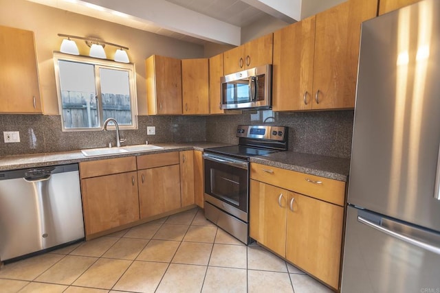 1801 Coast Blvd, Del Mar, CA 92014 - kitchen featuring appliances with stainless steel finishes, a sink, tasteful backsplash, dark countertops, and light tile patterned flooring