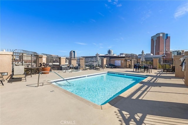 community pool featuring a patio area and fence