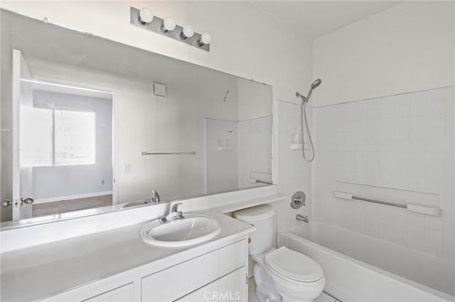bathroom with washtub / shower combination, toilet, and vanity