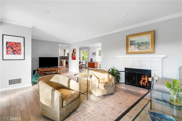 410 Via Mesa Grande, Redondo Beach, CA 90277 - living room with wood finished floors, a tiled fireplace, ornamental molding, and baseboards