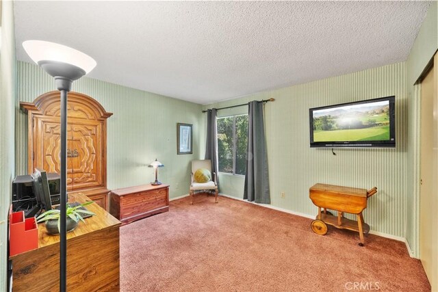 sitting room featuring baseboards, a textured ceiling, wallpapered walls, and carpet