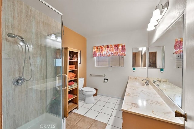 bathroom featuring toilet, a sink, tile patterned flooring, and a shower stall