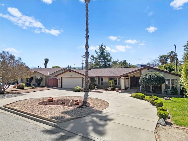 ranch-style home with an attached garage and curved driveway