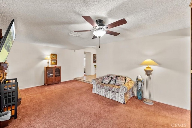 living area featuring baseboards, carpet floors, a textured ceiling, and a ceiling fan
