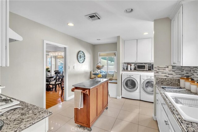 630 King St, Monrovia, CA 91016 - washroom featuring washing machine and dryer, light tile patterned flooring, and recessed lighting