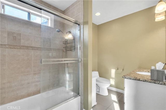 full bathroom with baseboards, toilet, enclosed tub / shower combo, vanity, and tile patterned flooring
