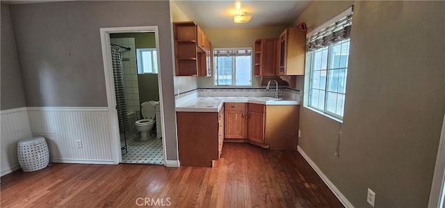 630 King St, Monrovia, CA 91016 - kitchen with open shelves, dark wood-type flooring, brown cabinetry, and a wainscoted wall