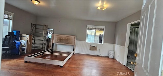 630 King St, Monrovia, CA 91016 - bedroom featuring wood finished floors, a wall unit AC, a wainscoted wall, and an office area