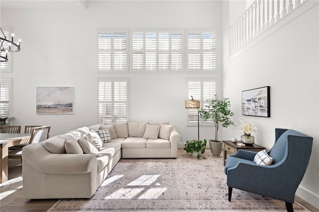 19732 Torres, Lake Forest, CA 92679 - living room featuring a high ceiling, a chandelier, healthy amount of natural light, and wood finished floors