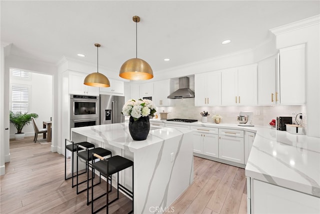 19732 Torres, Lake Forest, CA 92679 - kitchen featuring wall chimney exhaust hood, stainless steel appliances, backsplash, crown molding, and a kitchen bar