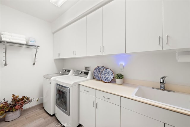 19732 Torres, Lake Forest, CA 92679 - laundry room featuring cabinet space, washer and clothes dryer, and light wood-type flooring