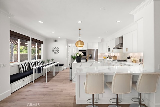 19732 Torres, Lake Forest, CA 92679 - kitchen featuring appliances with stainless steel finishes, wall chimney exhaust hood, recessed lighting, light countertops, and white cabinets