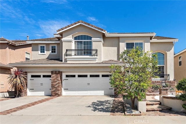 19732 Torres, Lake Forest, CA 92679 - traditional-style home with a balcony, a garage, concrete driveway, stucco siding, and brick siding