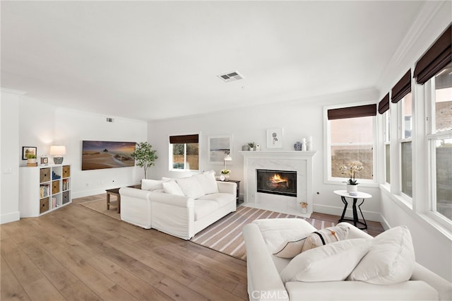 19732 Torres, Lake Forest, CA 92679 - living room featuring light wood finished floors, a high end fireplace, baseboards, and crown molding