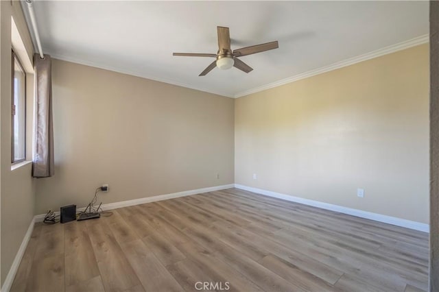 spare room with wood finished floors, baseboards, and ceiling fan