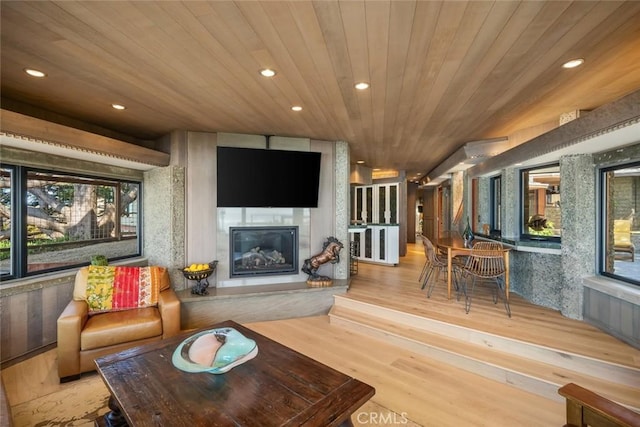 2431 Sherwood Dr, Cambria, CA 93428 - living room with wood finished floors, recessed lighting, wooden ceiling, and a glass covered fireplace