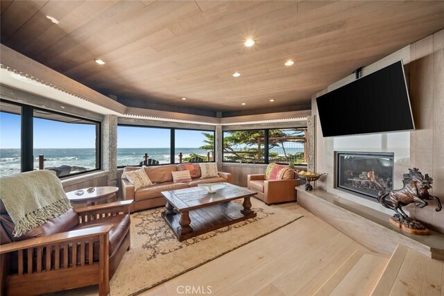 2431 Sherwood Dr, Cambria, CA 93428 - living room with a fireplace, recessed lighting, wood ceiling, and hardwood / wood-style flooring