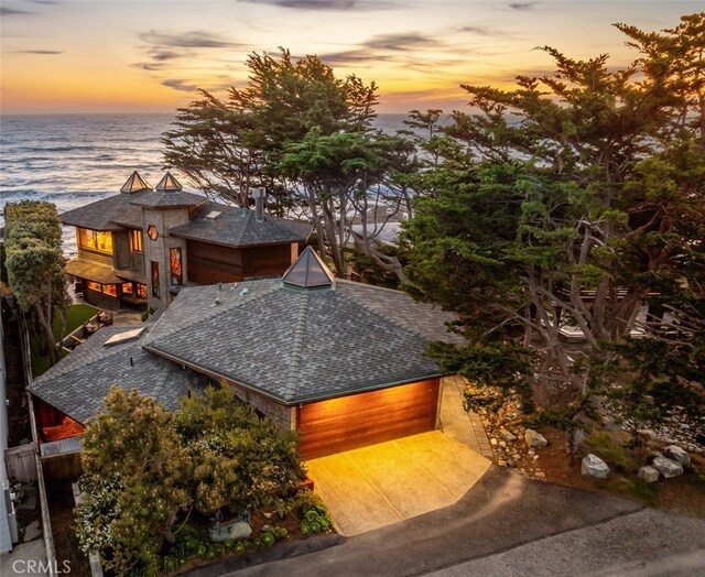 2431 Sherwood Dr, Cambria, CA 93428 - view of front of house with a water view, a shingled roof, concrete driveway, and a garage