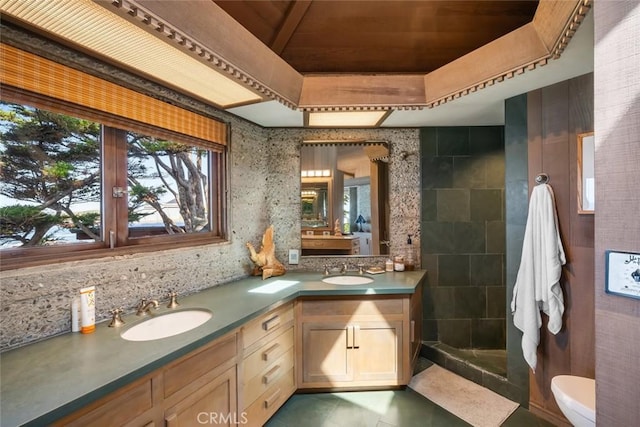 2431 Sherwood Dr, Cambria, CA 93428 - bathroom featuring double vanity, a sink, a tray ceiling, and tiled shower