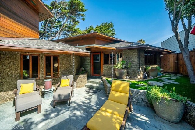 2431 Sherwood Dr, Cambria, CA 93428 - rear view of property with fence, stone siding, and a patio