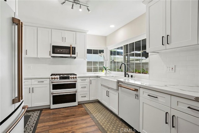 26211 Avenida Deseo, Mission Viejo, CA 92691 - kitchen with white appliances, dark wood-type flooring, backsplash, white cabinets, and light stone countertops