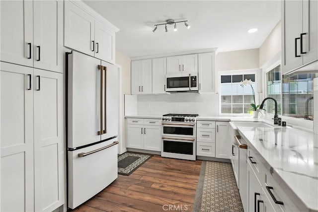 26211 Avenida Deseo, Mission Viejo, CA 92691 - kitchen featuring high end appliances, dark wood finished floors, white cabinets, light stone countertops, and recessed lighting