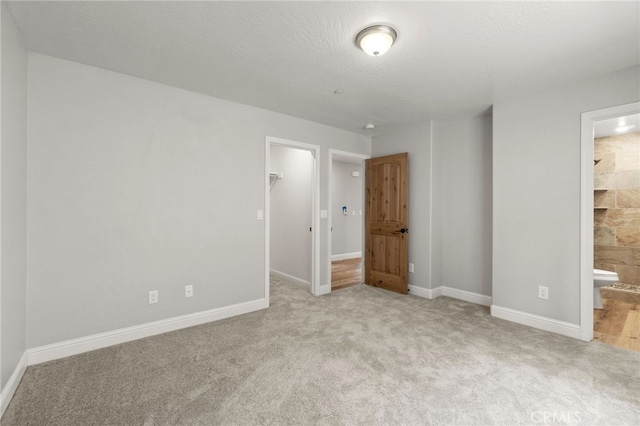 43179 E Sugar Pine Dr, Oakhurst, CA 93644 - unfurnished bedroom with baseboards, a spacious closet, carpet, and ensuite bath