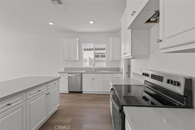 kitchen featuring a sink, light countertops, white cabinetry, and stainless steel appliances